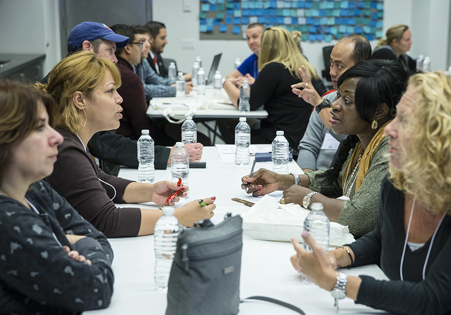 Educators deep in discussion during a recent professional development workshop. Photo by Jin Lee.