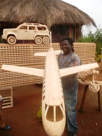 B-ARTIST FOMBE NFOR CELESTINE HOLDING A 1.5M LONG PLANE.JPG