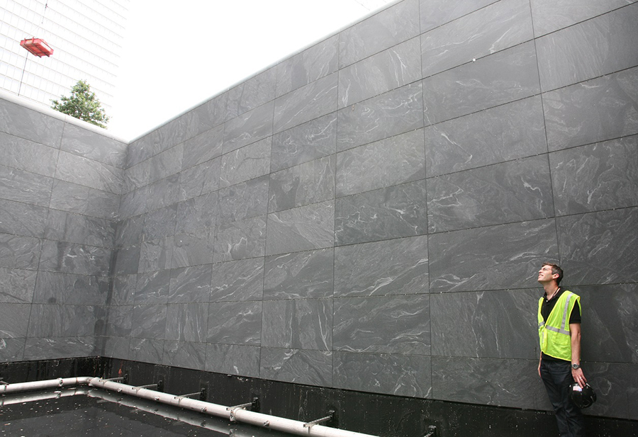 Architect Michael Arab stands inside one of the reflecting pools before the 9/11 Memorial was completed.