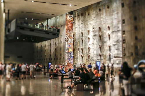 Visitors fill Foundation Hall at the Museum. The Last Column towers over the visitors.