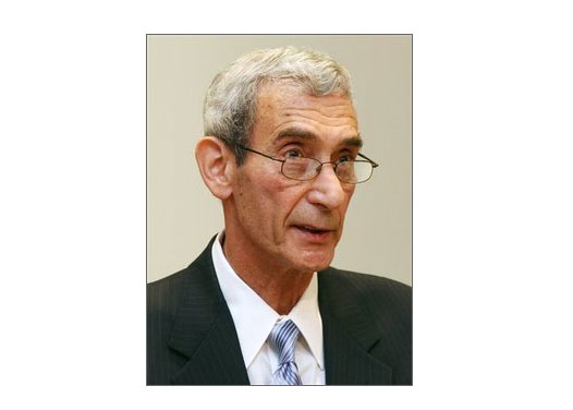 This portrait photo shows Dr. Charles Hirsch in a suit and tie.