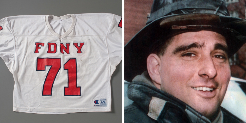 The red and white FDNY football jersey of firefighter Durrell ‘Bronko’ Pearsall is displayed on a gray surface at the Museum. An adjacent image shows Pearsall smiling in his bunker gear.