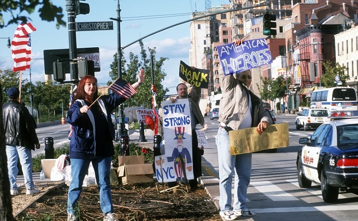 Several people stand in the median of the West Side Highway holding signs in support of rescue and recovery workers in the weeks after September 11. The signs they’re holding include messages like “Stay Strony NYC” and “We Love Our Heroes.”