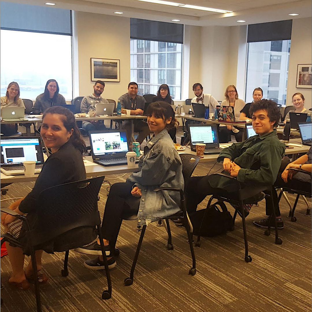 Museum staff, masked, at laptops during live chat