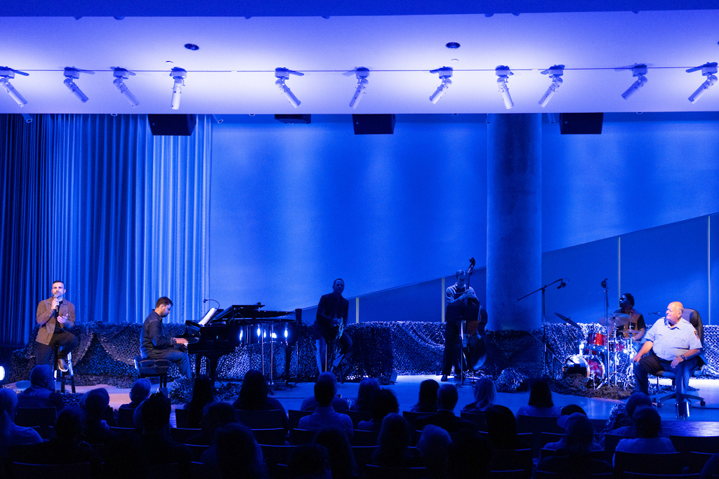 Behind The Lines: A 9/11 Story Stage - lit blue with the performers preparing to go live