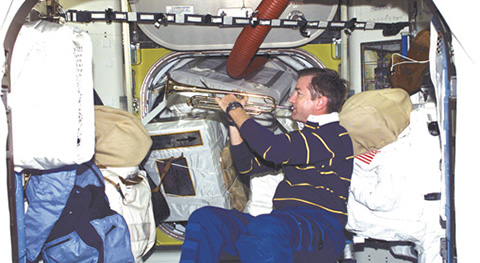 Image of astronaut playing taps