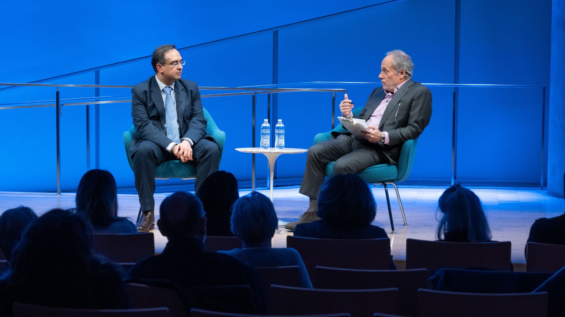 From left: Dr. Sajjan Gohel and Clifford Chanin seated on stage.