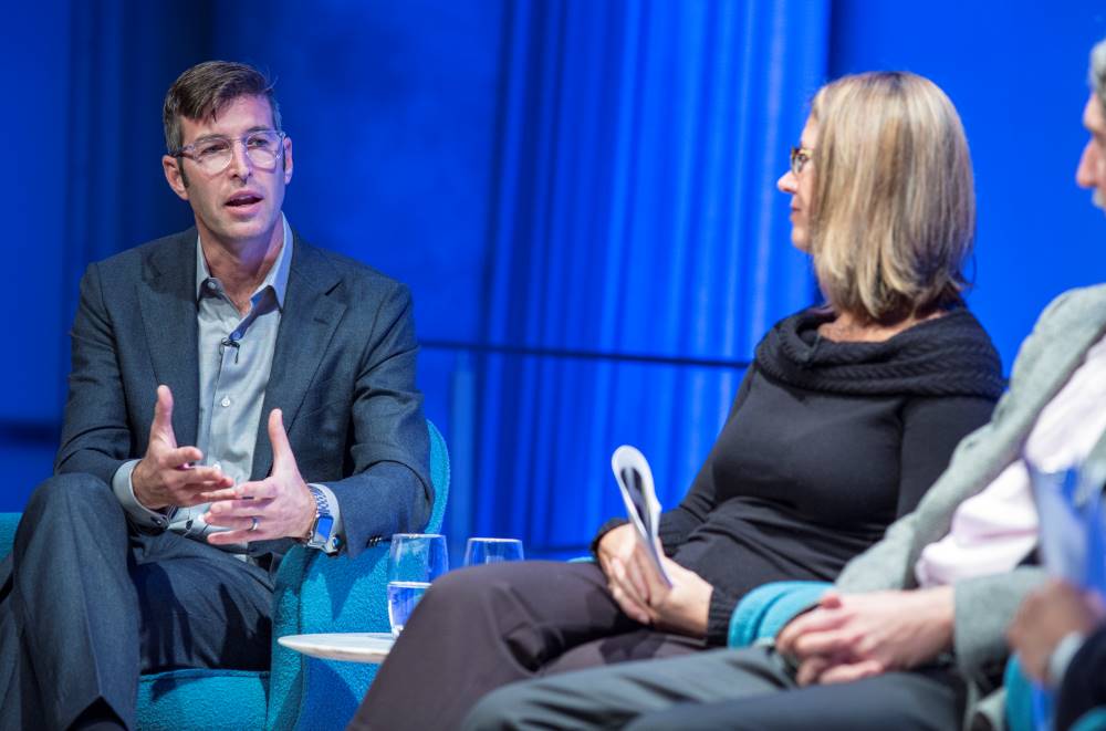 Handel Architects LLP partner Michael Arad speaks onstage as he takes part in the public program, The Architecture of Remembrance. Paul Murdoch Architects President Paul Murdoch and KBAS partner Julie Beckman are seated to his left listening on.