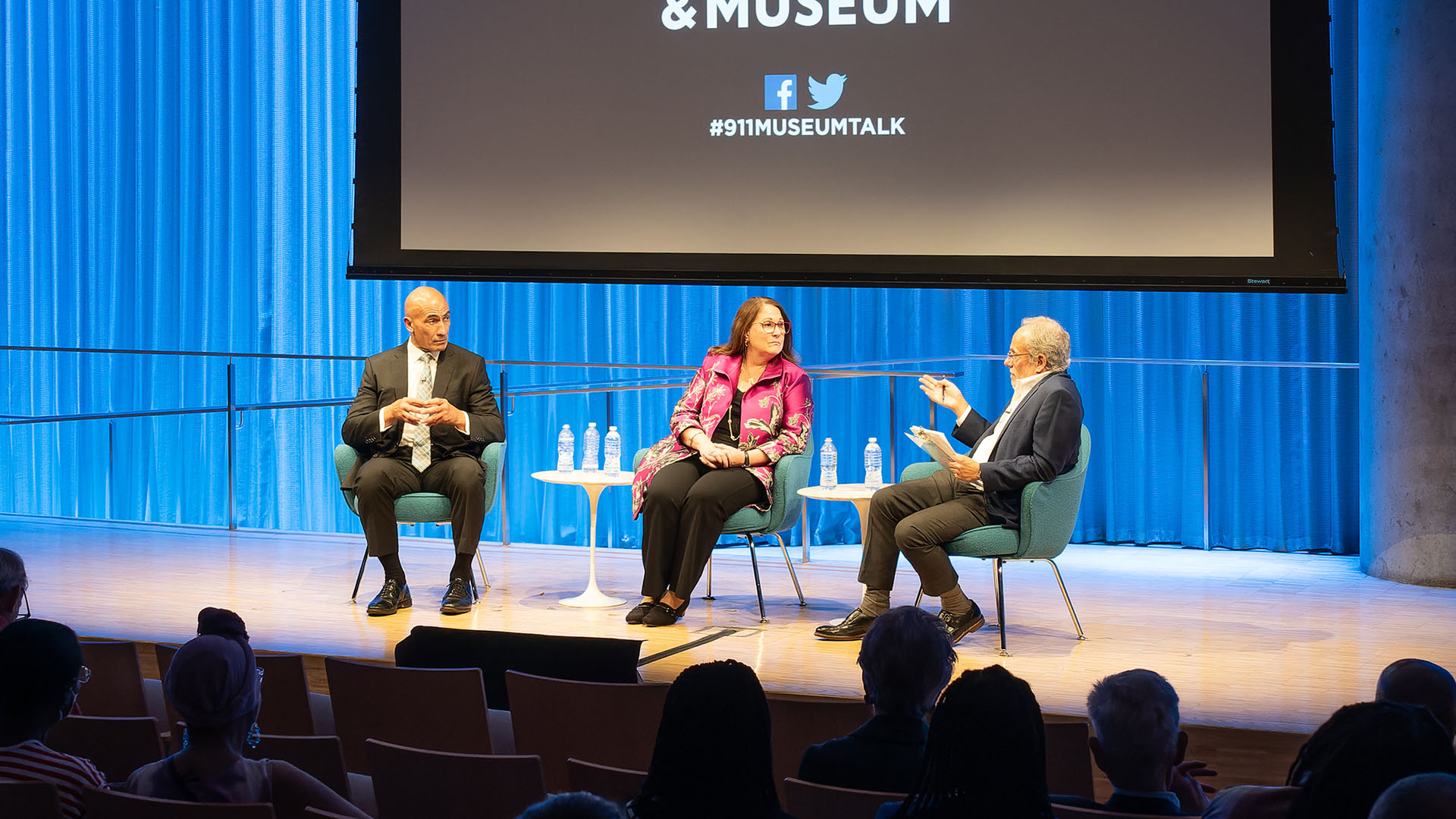 From left: John Liguori, Mary E. Galligan and Clifford Chanin (talking) on stage