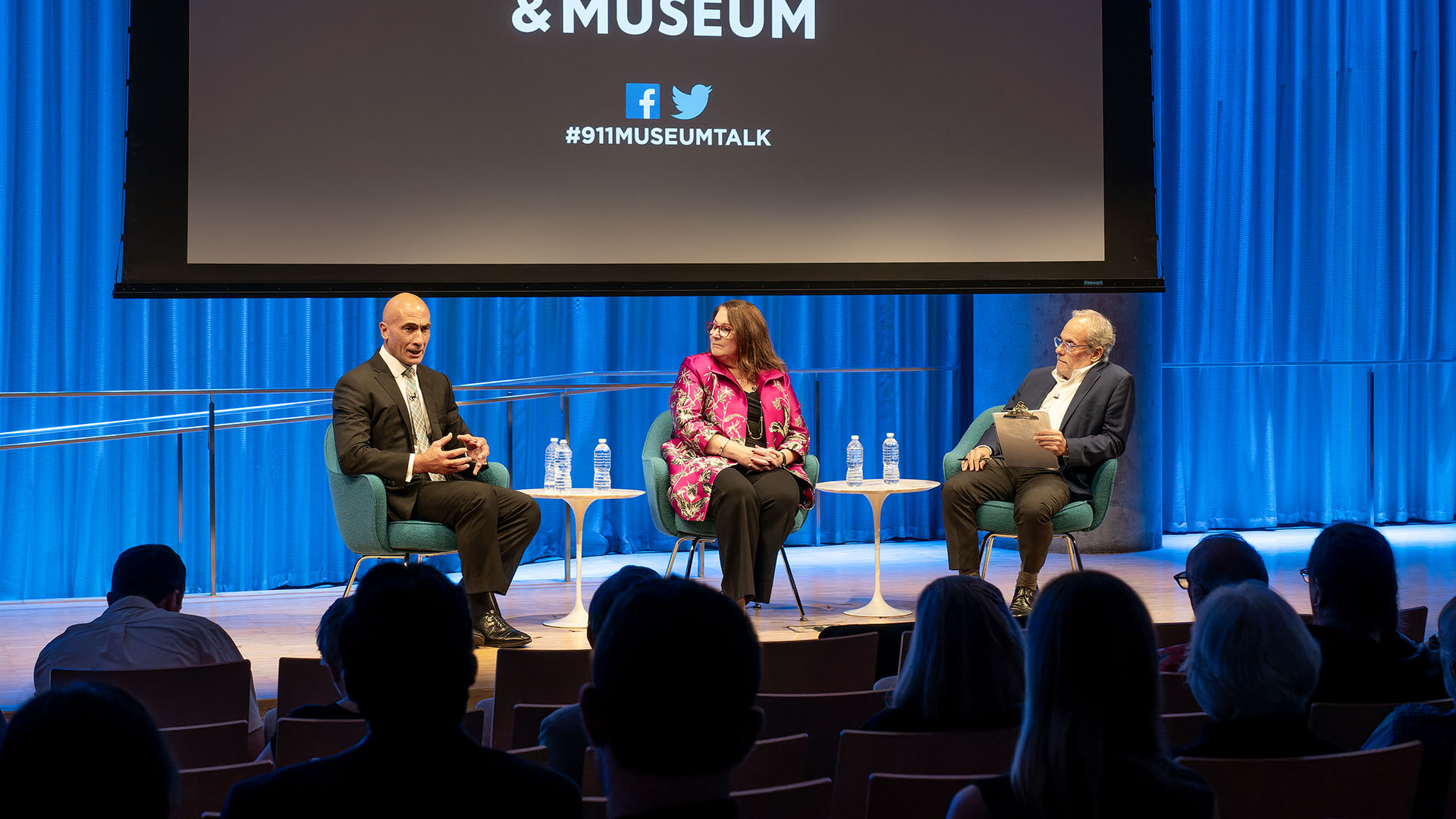 From left: John Liguori talking to Mary E. Galligan and Clifford Chanin on stage