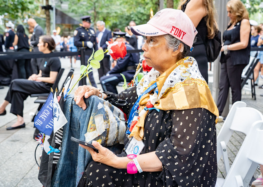 a family member in an FDNY never forget baseball cap at the ceremony