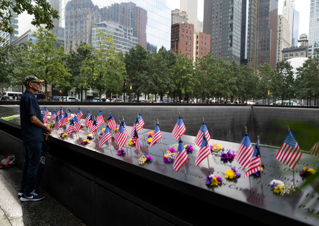 flags and flowers placed on the Memorial