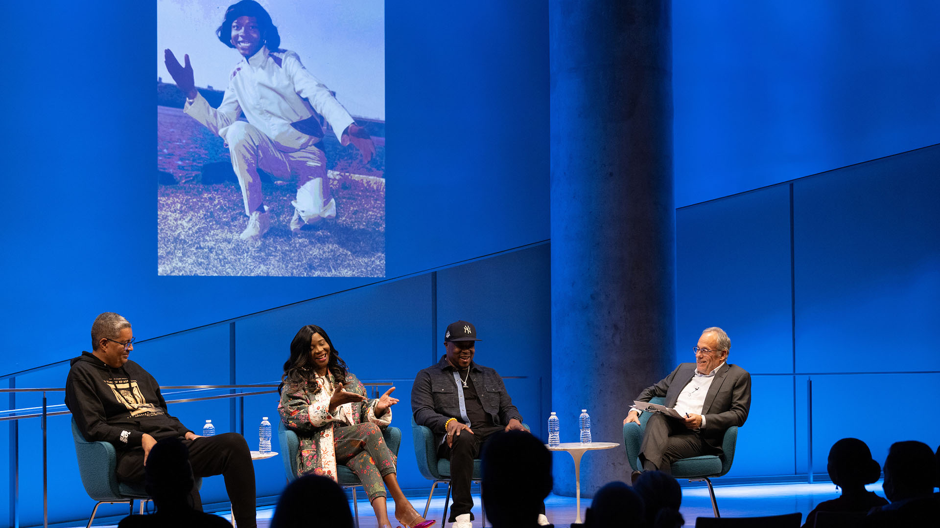 From left: Rocky Bucano, Dr. MC Debbie D (talking), Chuck Creekmur, and Clifford Chanin on stage.  