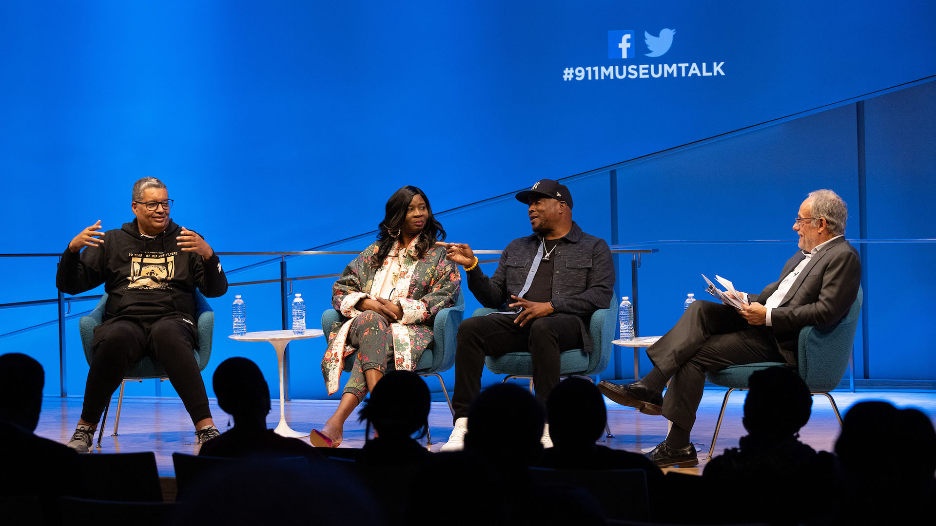 From left: Rocky Bucano, Dr. MC Debbie D, Chuck Creekmur (talking), and Clifford Chanin on stage