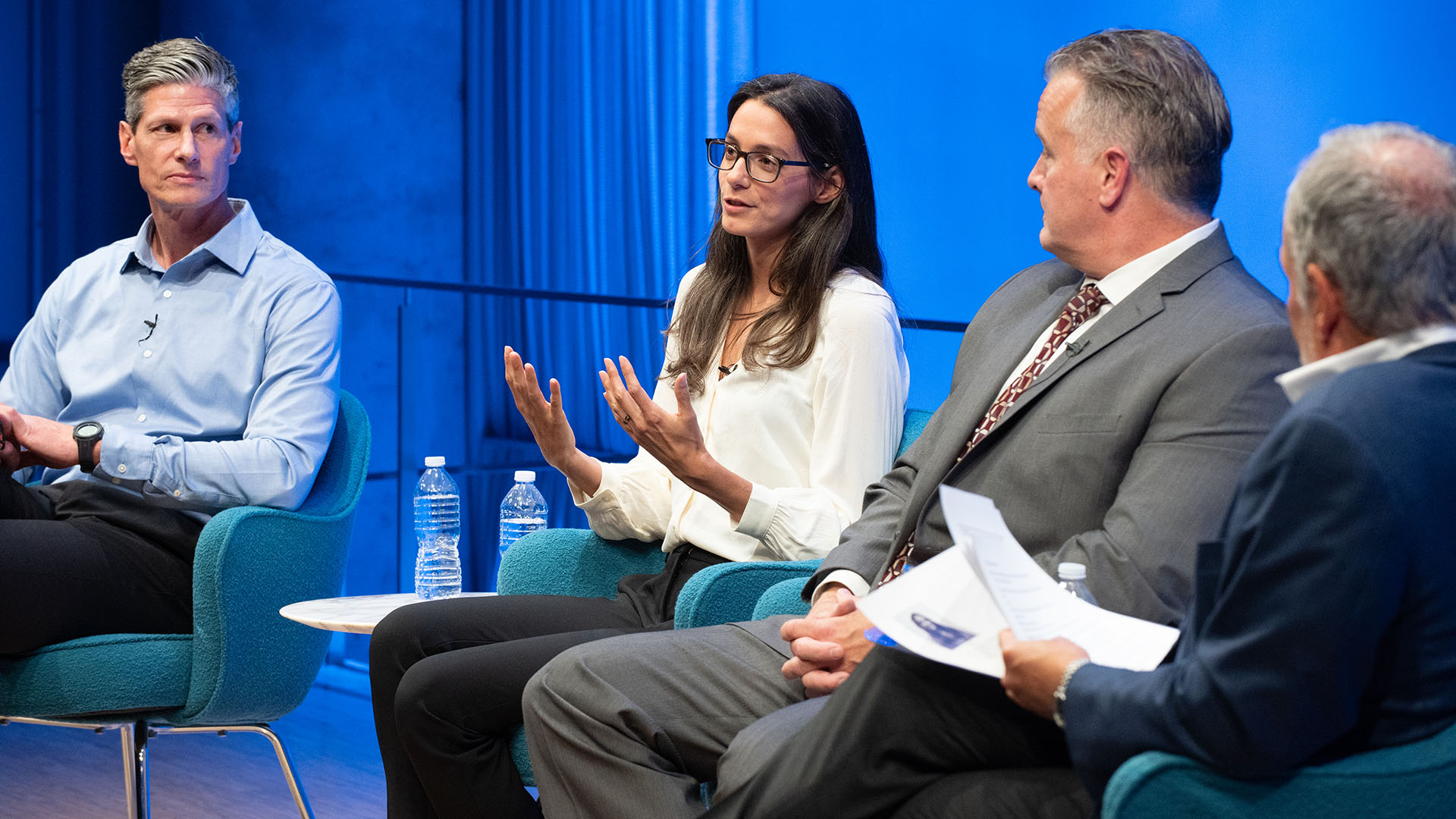 From left: Carl D. Gajewski, Jennifer K. Odien (talking), Mark Desire and Clifford Chanin on stage