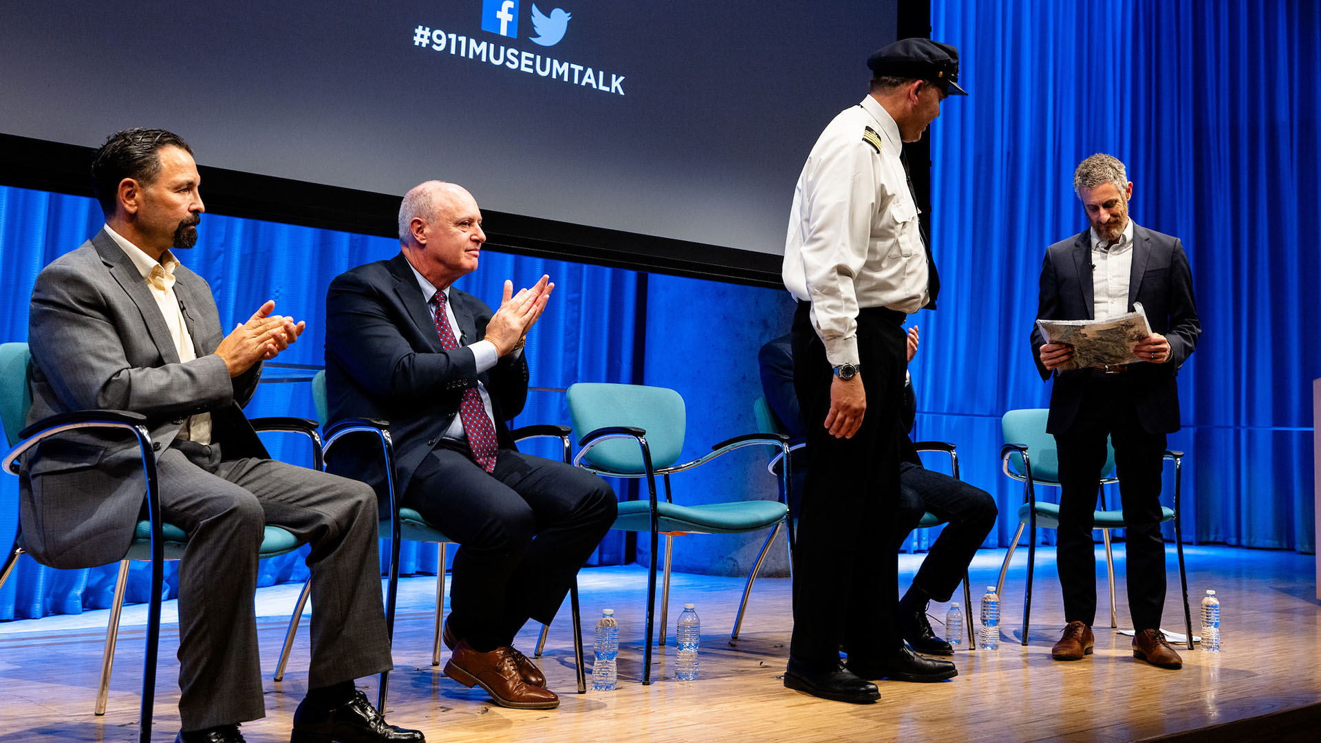 Richard Thornton hands a document to Noah Rauch as Gulmar Parga, John Hillin, and Eddie Rosenstein clap.