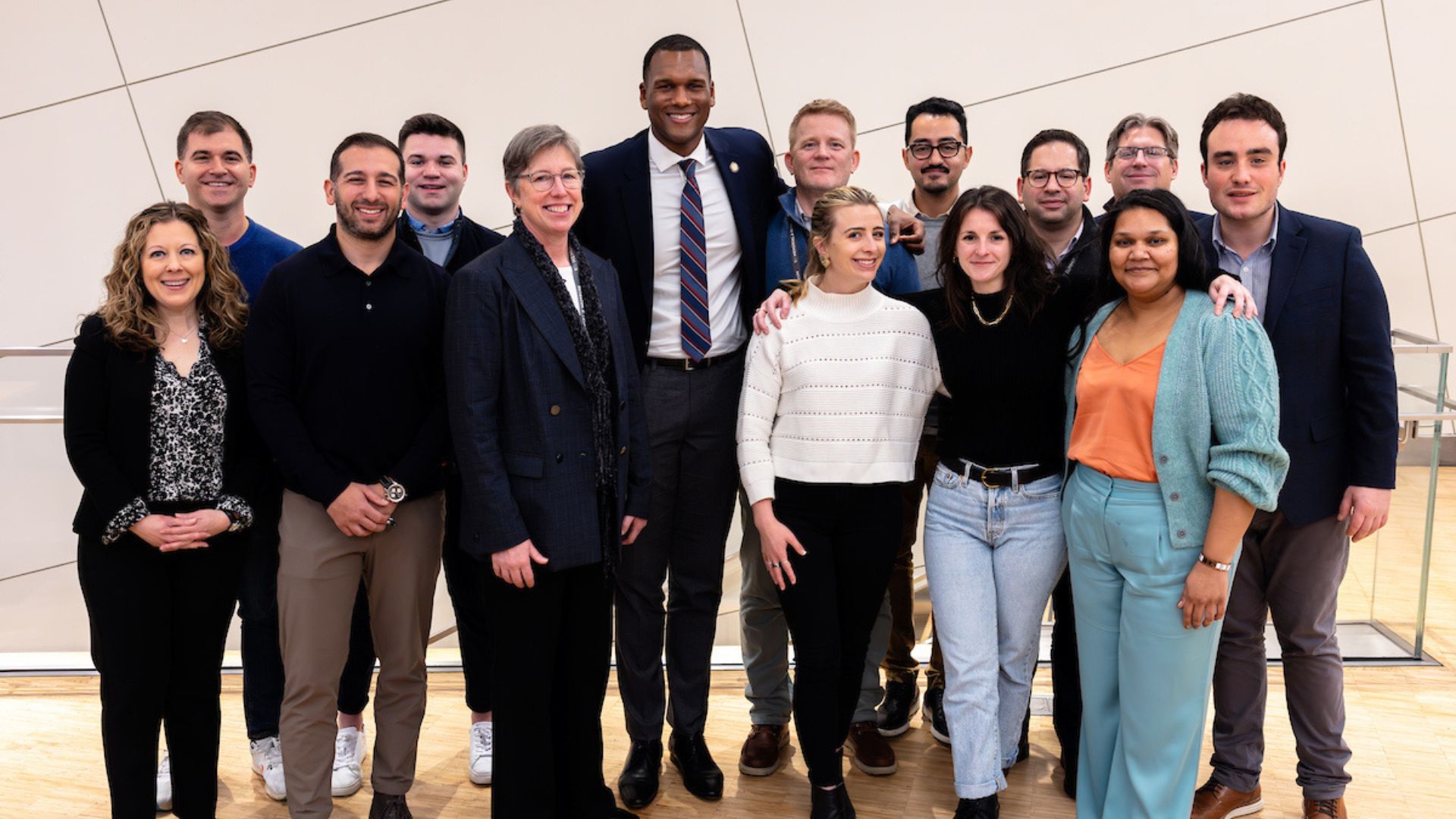 A large group of Visionaries stands together smiling