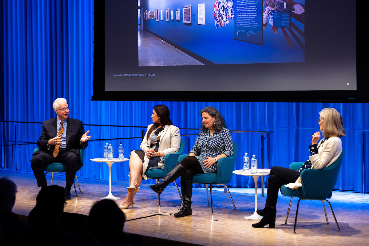Dr. Tom Demaria talks on stage with Amy Gardner, Traci Molloy, and Jan Ramirez listening