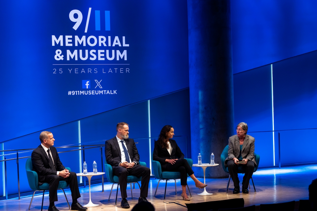 The four speakers talk on stage.