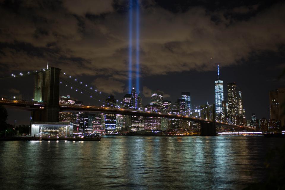 The Tribute in Light shines above lower Manhattan in this photo taken across the East River in Brooklyn. The Brooklyn Bridge is in the foreground. 