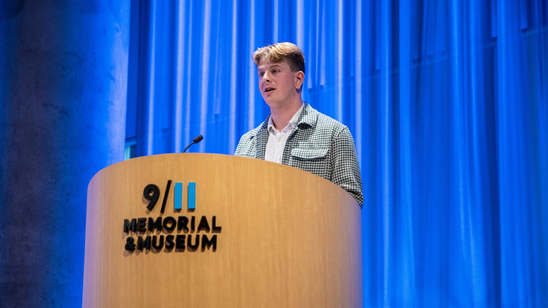 John Spade speaks at the podium 