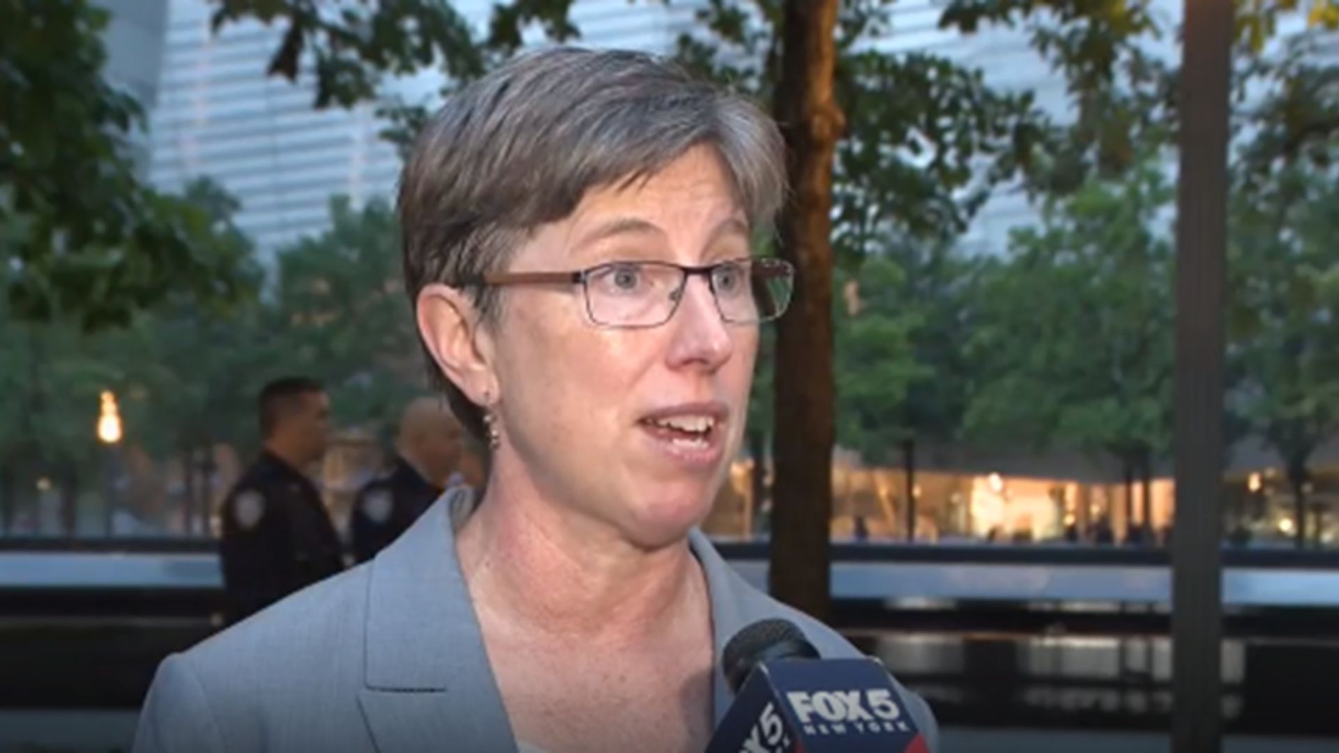 Beth Hillman speaks to a television reporter on the Memorial plaza 