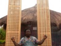 C-CELESTINE  INFRONT OF HIS ARTS WORK 4M TALL MADE OUT OF LOCAL BAMBOO.JPG