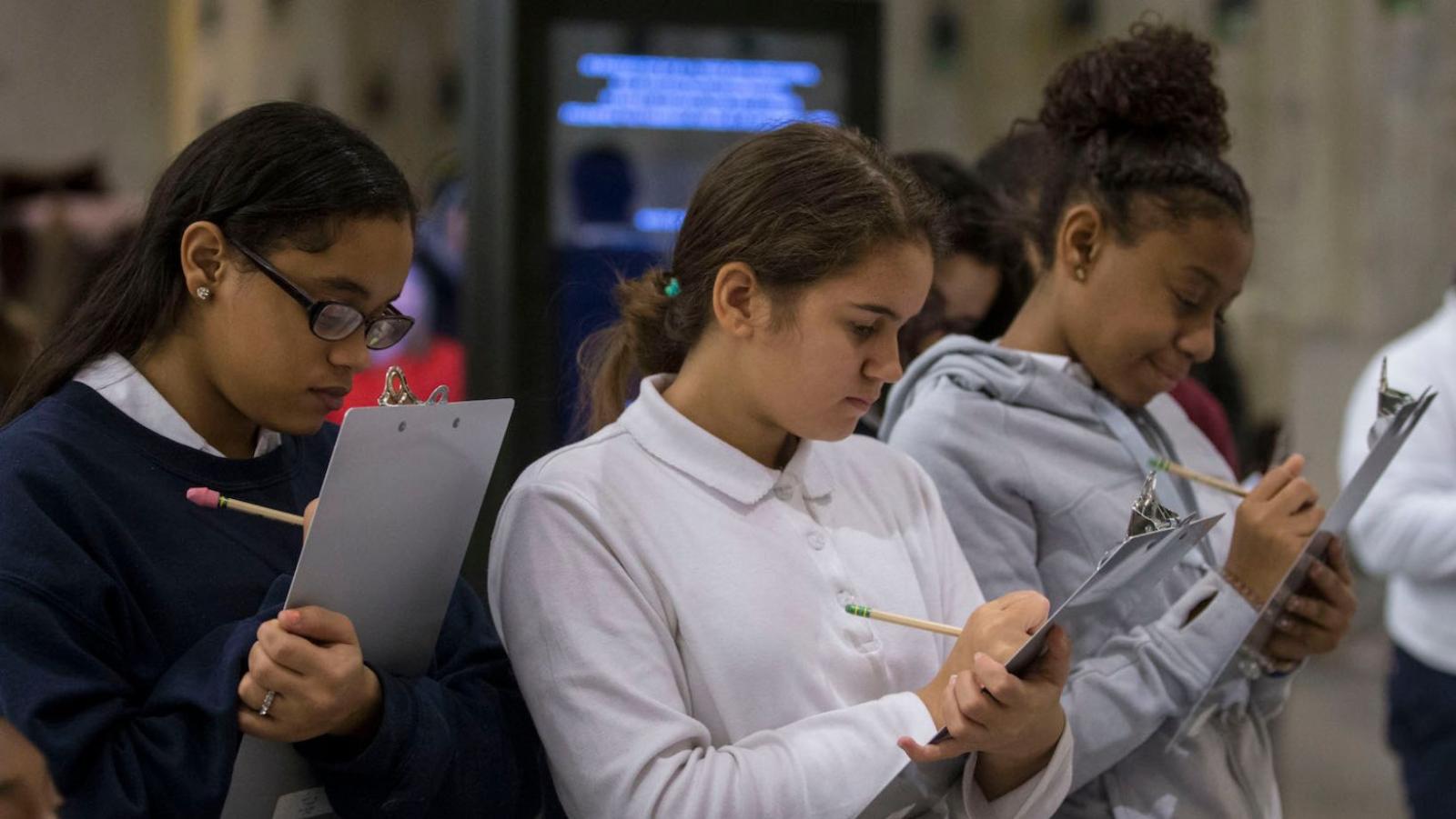 Students take notes on a field trip