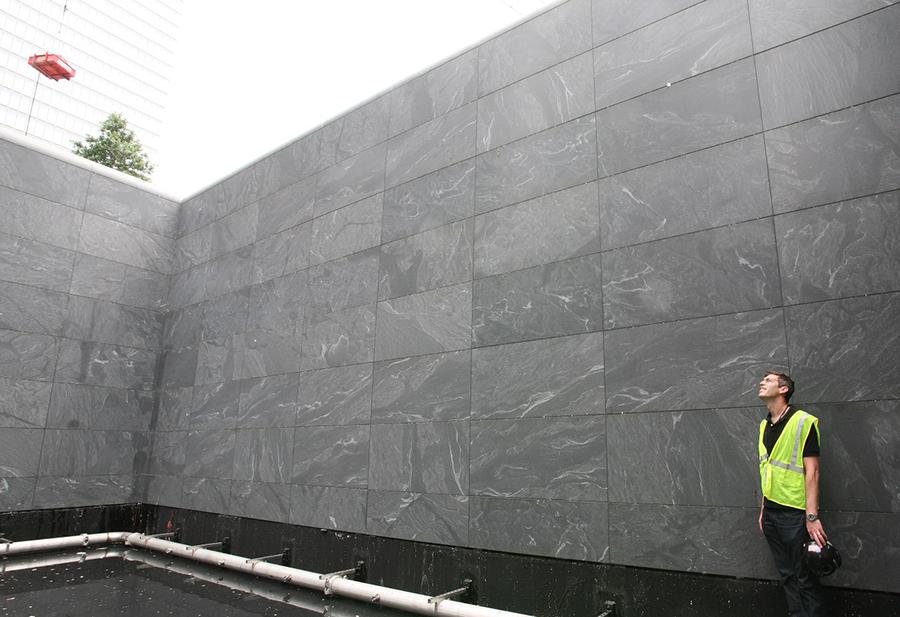 Architect Michael Arab stands inside one of the reflecting pools before the 9/11 Memorial was completed.