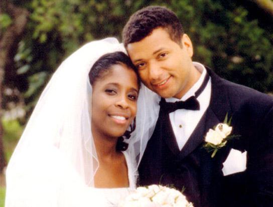 Melodie Homer and her husband, Leroy Homer Jr., smile for a wedding photo.