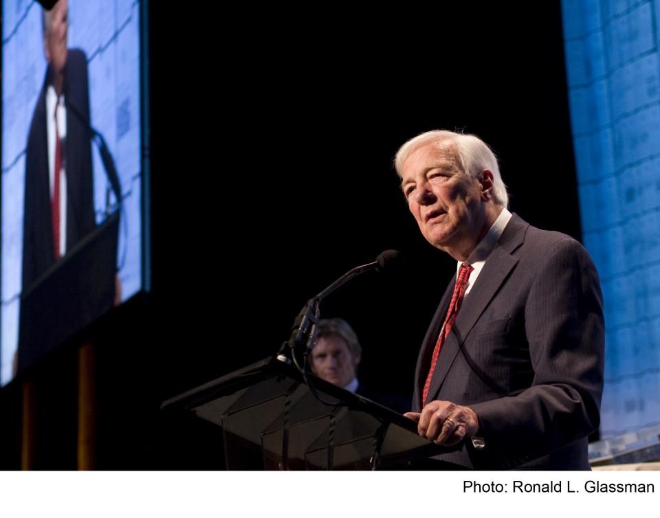 John C. Whitehead, founding chairman of the 9/11 Memorial & Museum, speaks at a podium.