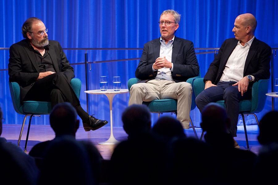 Mandy Patinkin, Alex Gansa, and Howard Gordon speak onstage at a public program at the 9/11 Memorial Museum’s Auditorium.