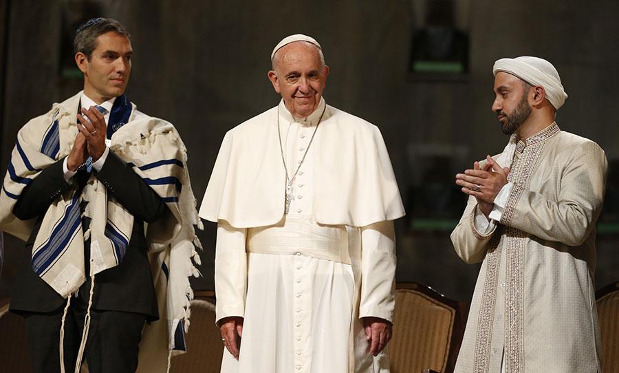 Pope Francis, Dr. Rabbi Elliot J. Cosgrove, and Imam Khalid Latif stand on a stage at the 9/11 Memorial Museum.