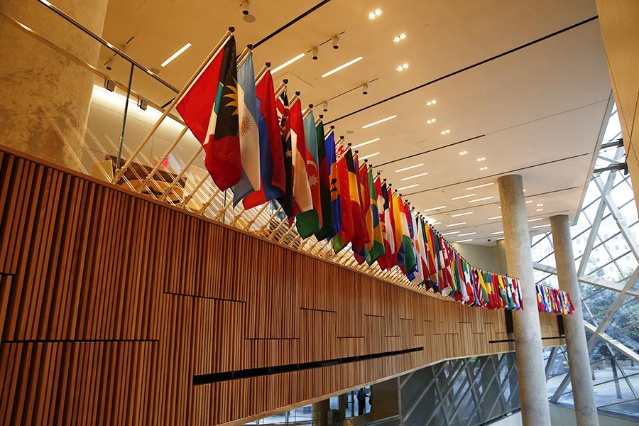 International flags hang in a row at the 9/11 Memorial Museum pavilion to commemorate the victims of the 9/11 attacks.