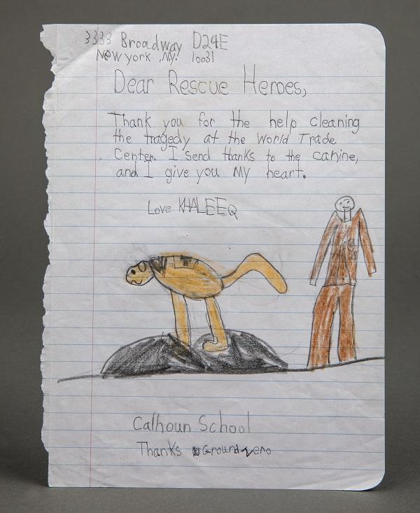 A child’s drawing thanks the heroes of 9/11 rescue and recovery efforts. The drawing has been sketched on ruled paper and shows a man and a dog and includes a note signed by a child named Khaleeq.