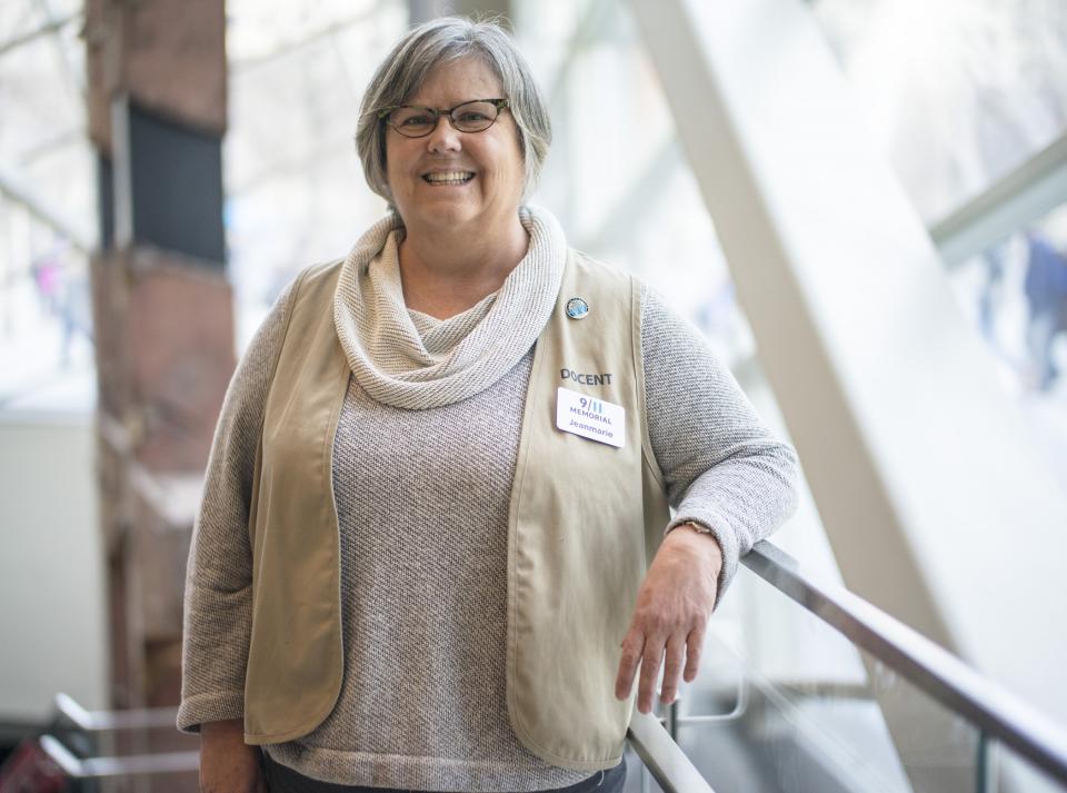 Docent Jeanmarie Hargrave poses for a photo on the ground level of the 9/11 Memorial Museum.